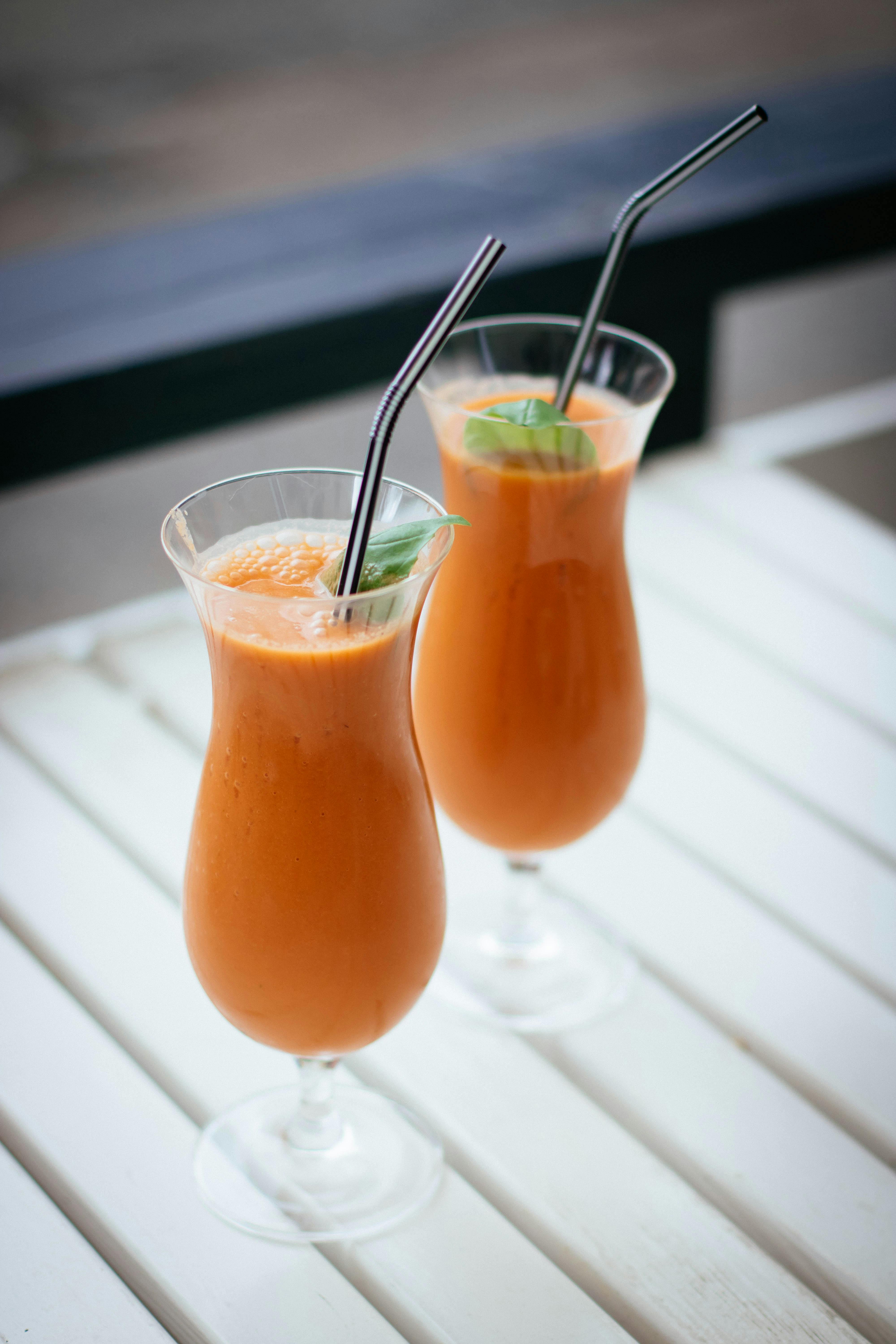 Two Iced Orange Smoothies on Table
