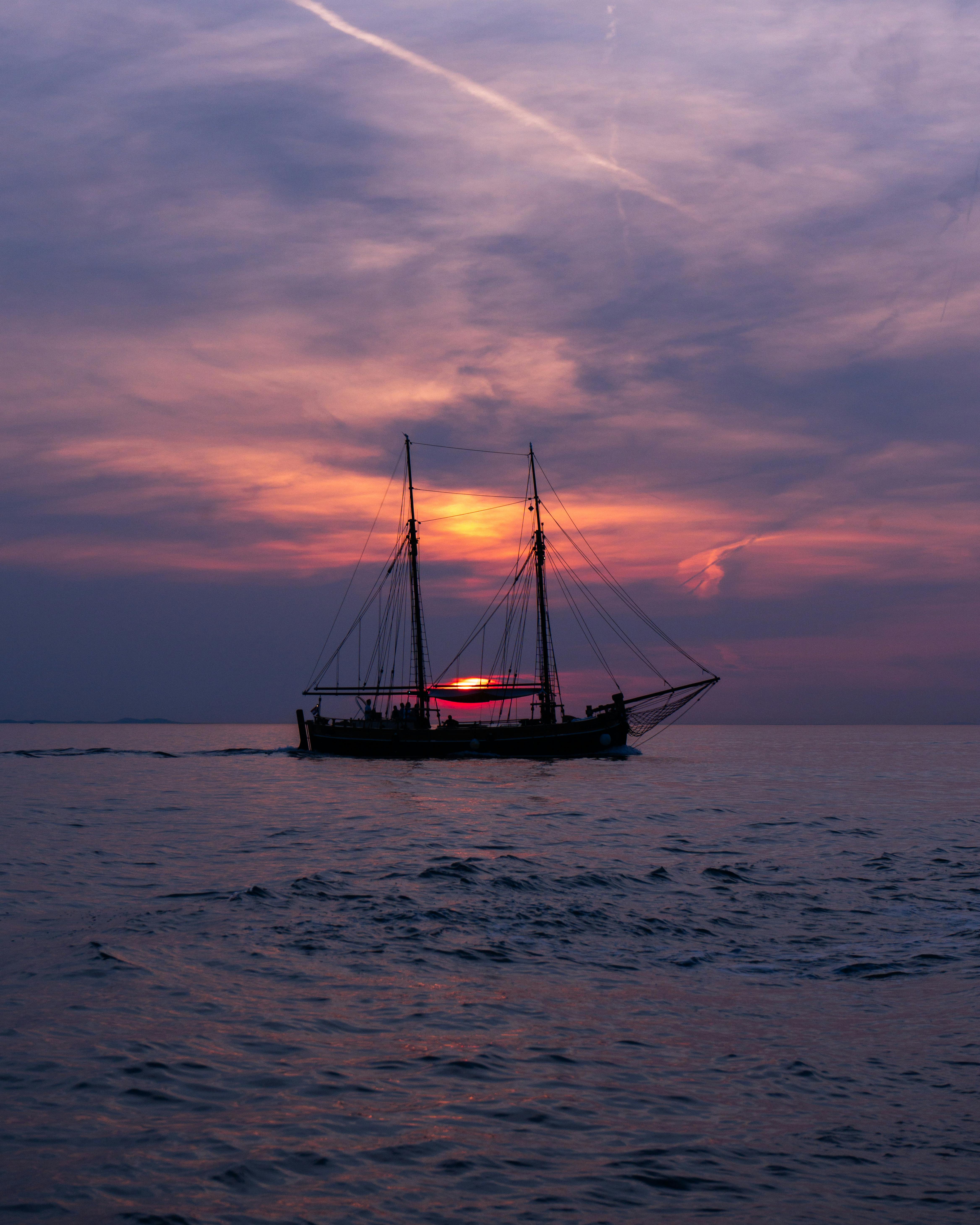 Sailboat Silhouette on Sea at Sunset