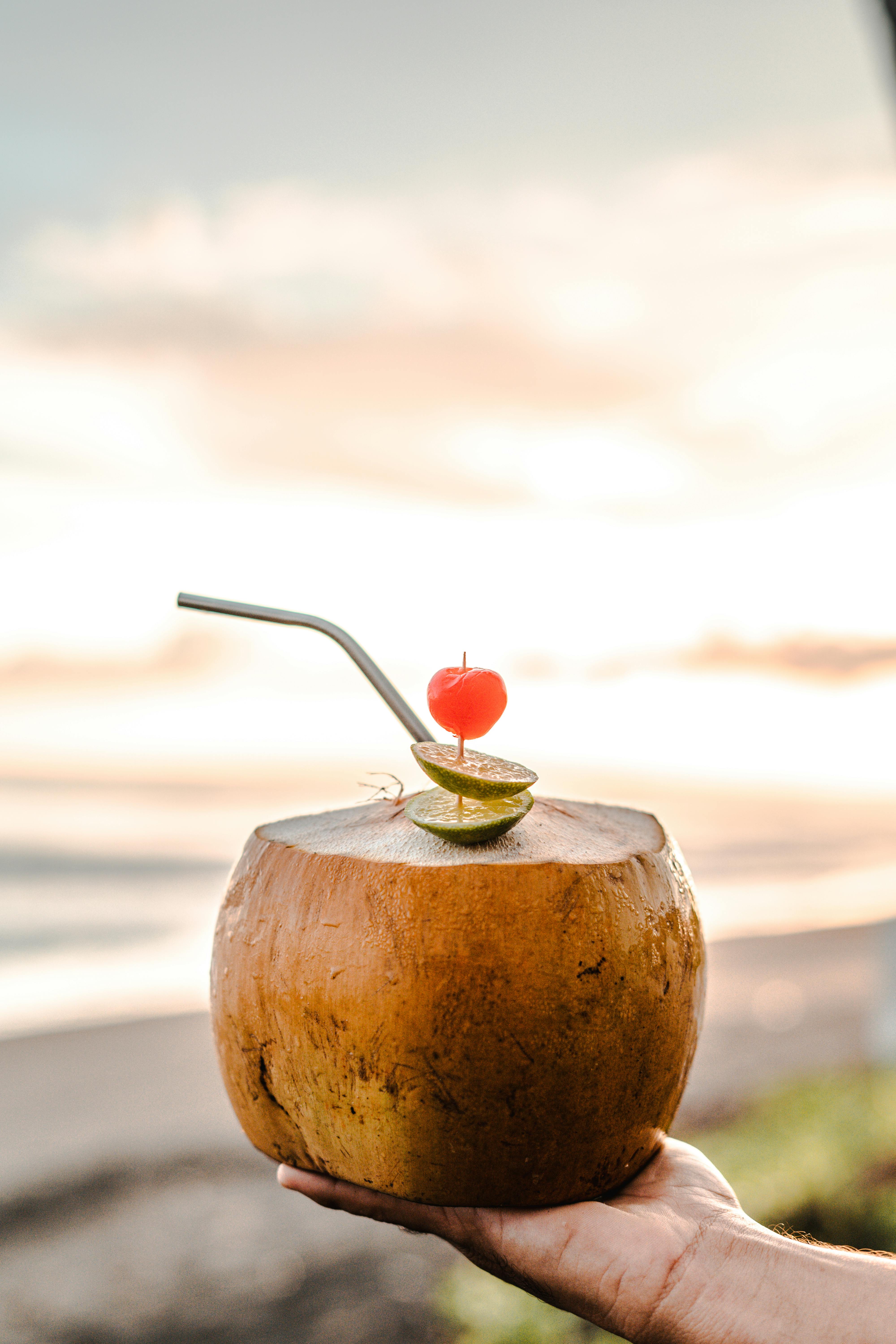 Garnished Coconut Drink At Beach Sunset