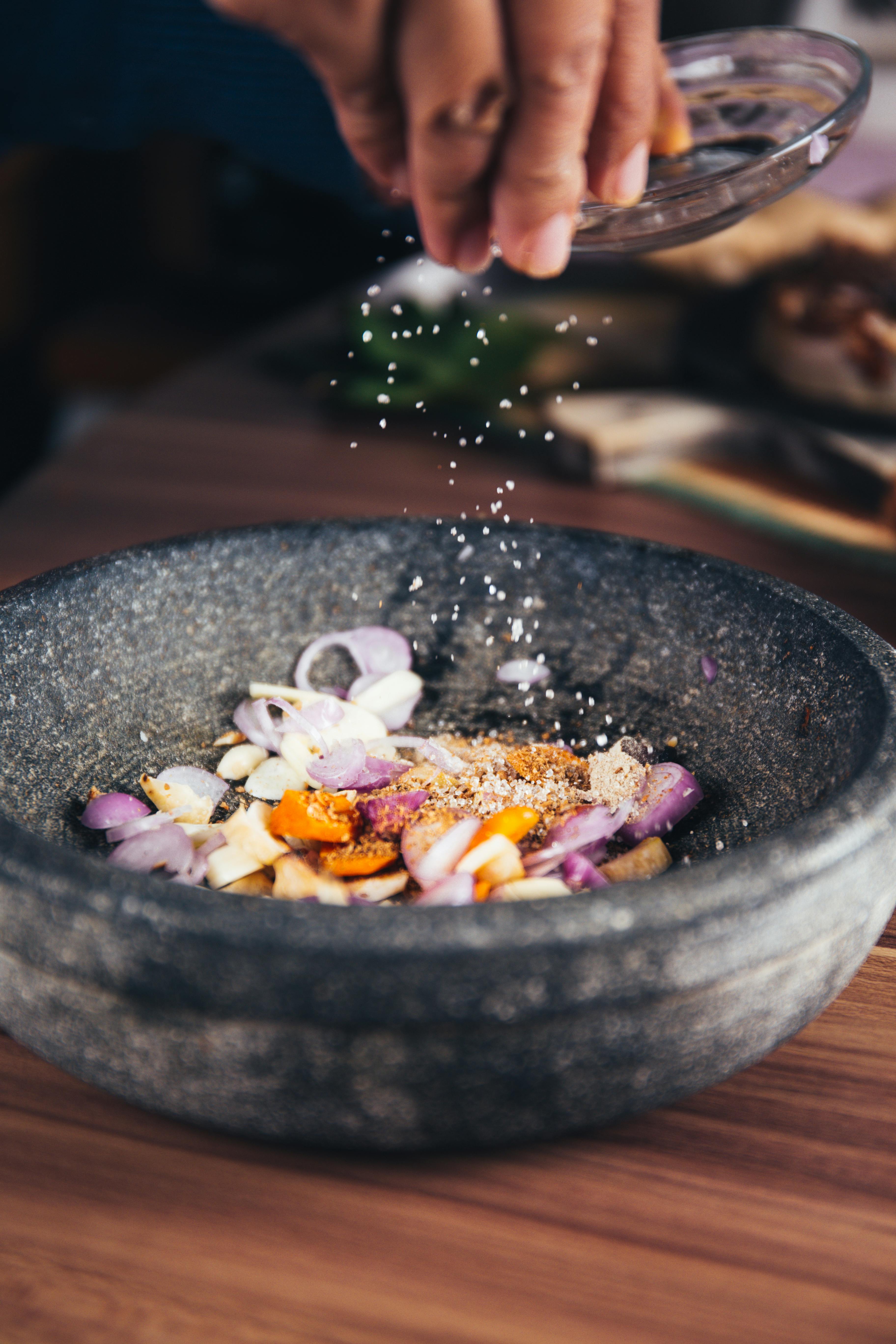 Sprinkling Salt Into Cooking Ingredients