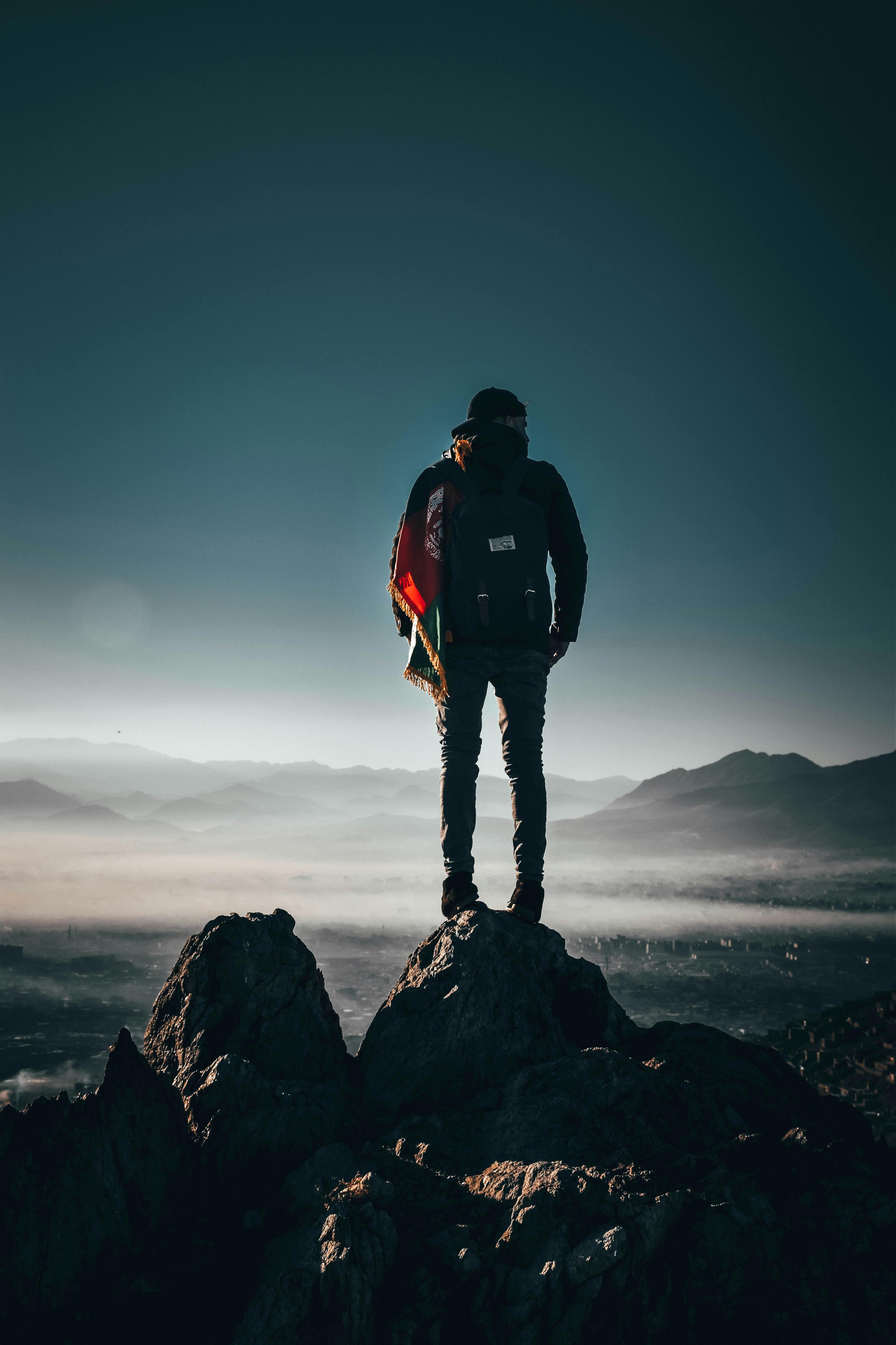 Hiker on Mountain Peak Overlooking Valley
