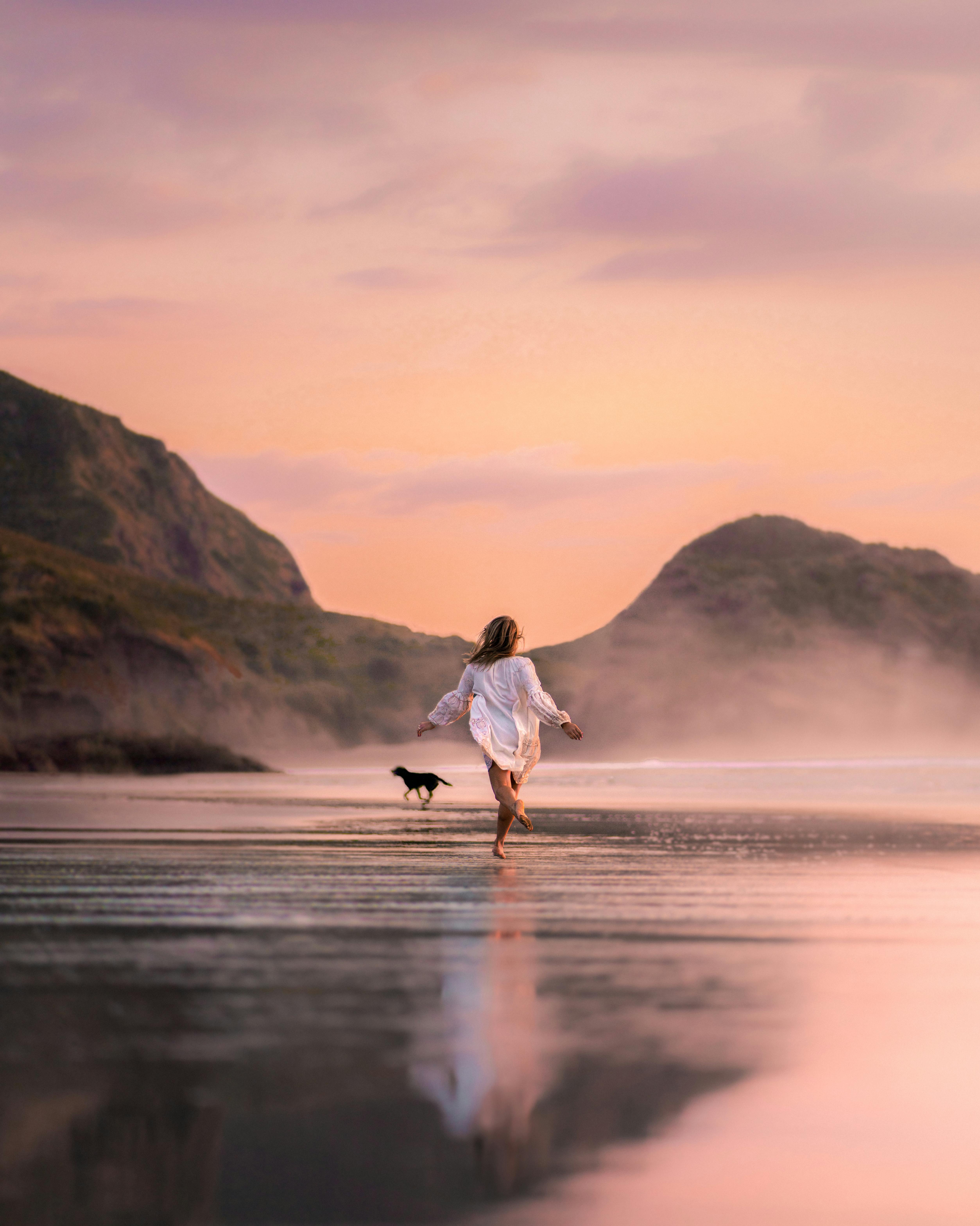 Woman and Dog Running on Beach at Sunset — Beauty