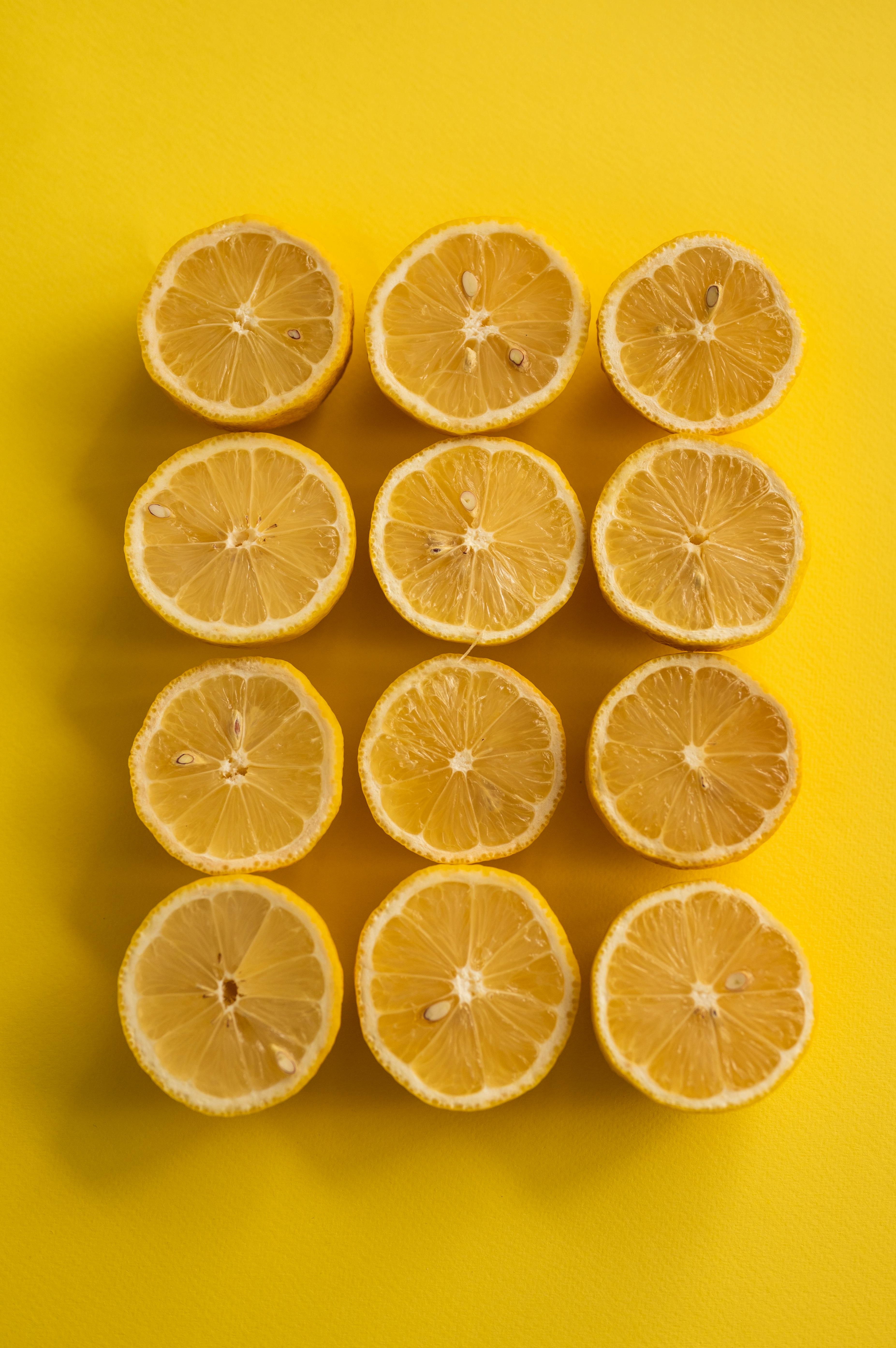 Halved Lemons on Yellow Background — Food
