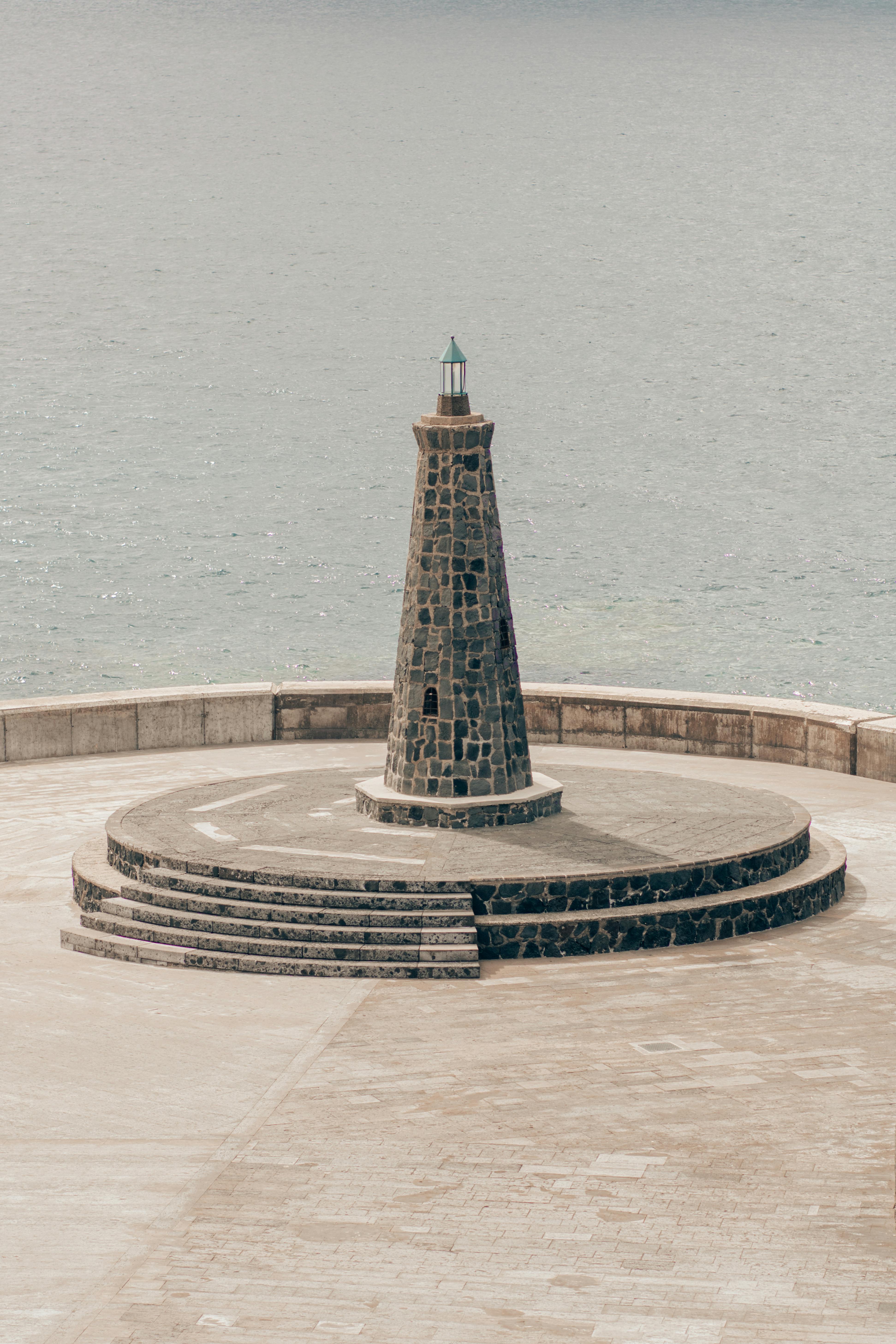 Stone Lighthouse by Calm Sea — Backgrounds