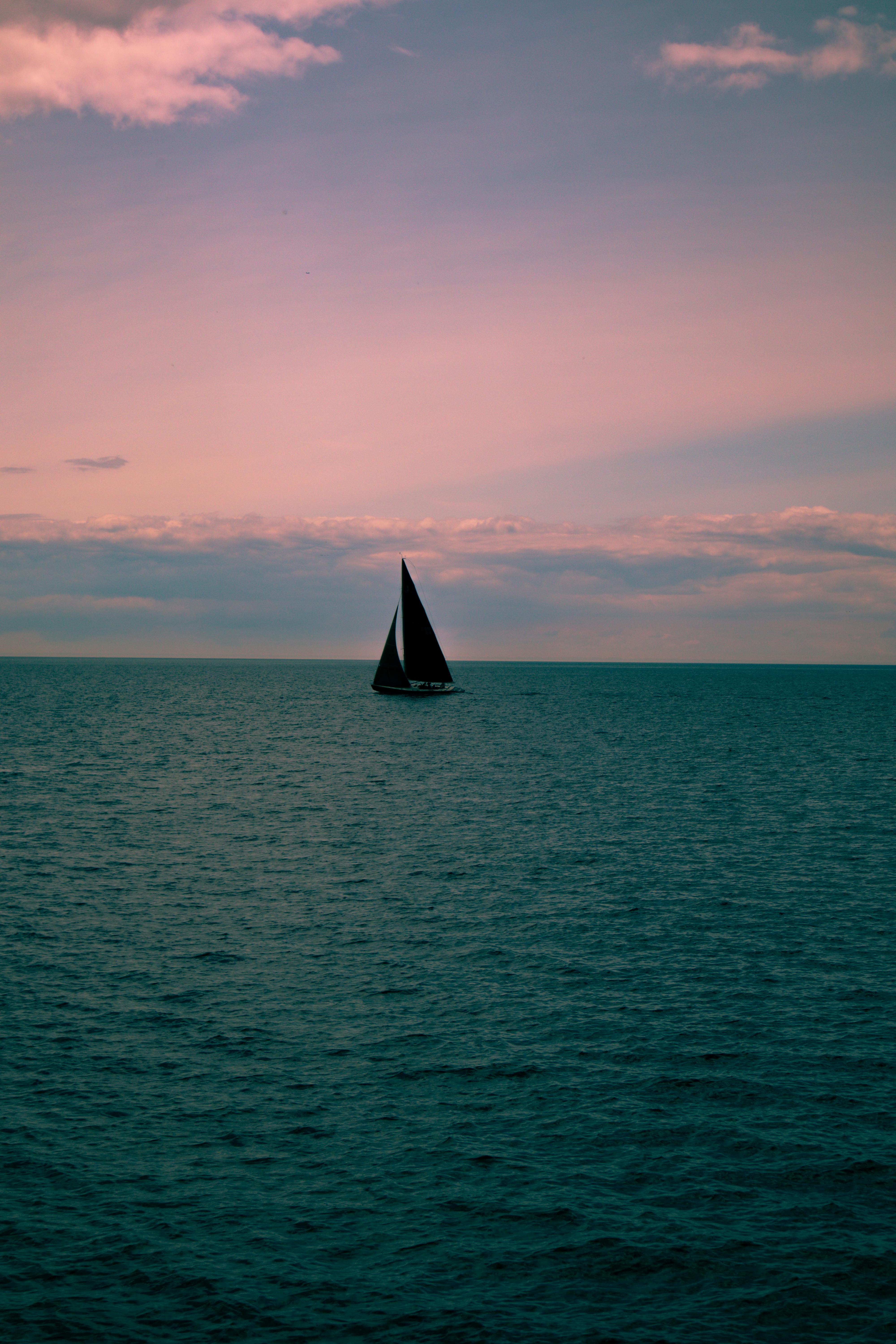 Sailboat on Calm Sea at Sunset — Backgrounds