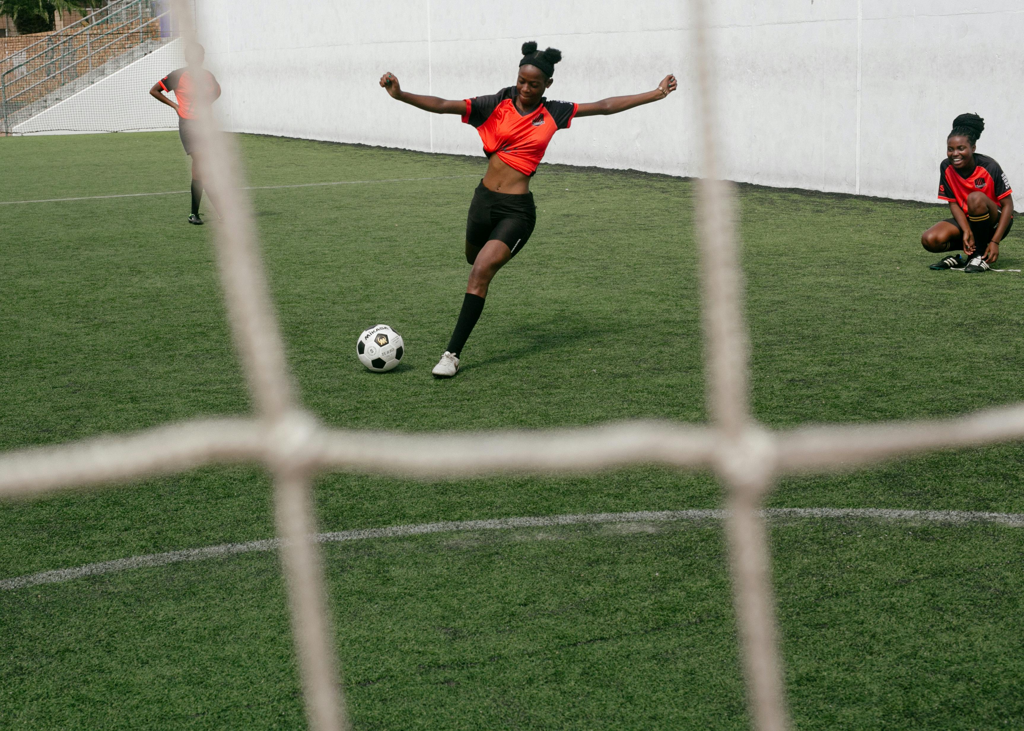 Female Soccer Player Prepares to Kick Ball