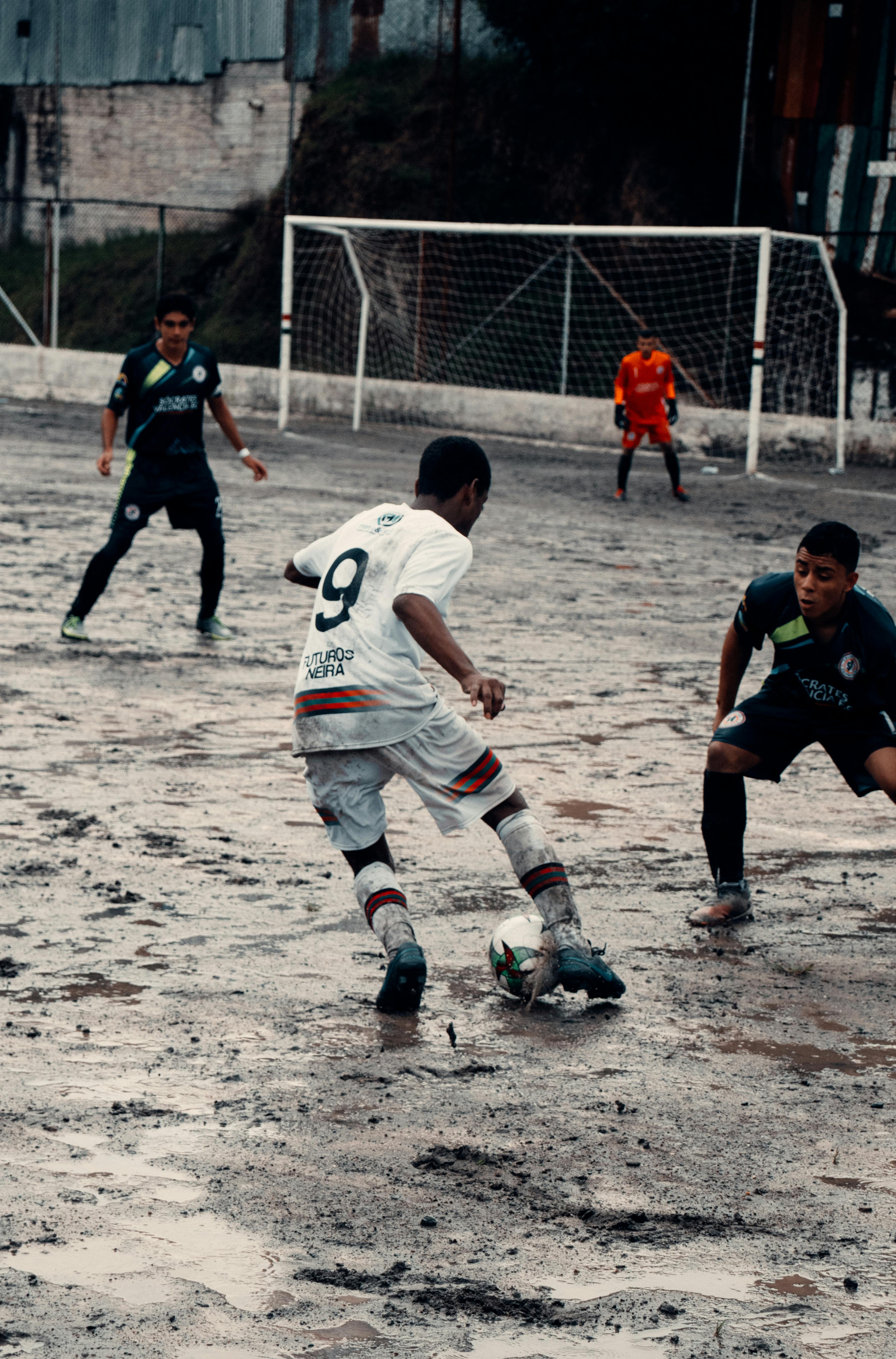 Soccer Match on Muddy Pitch