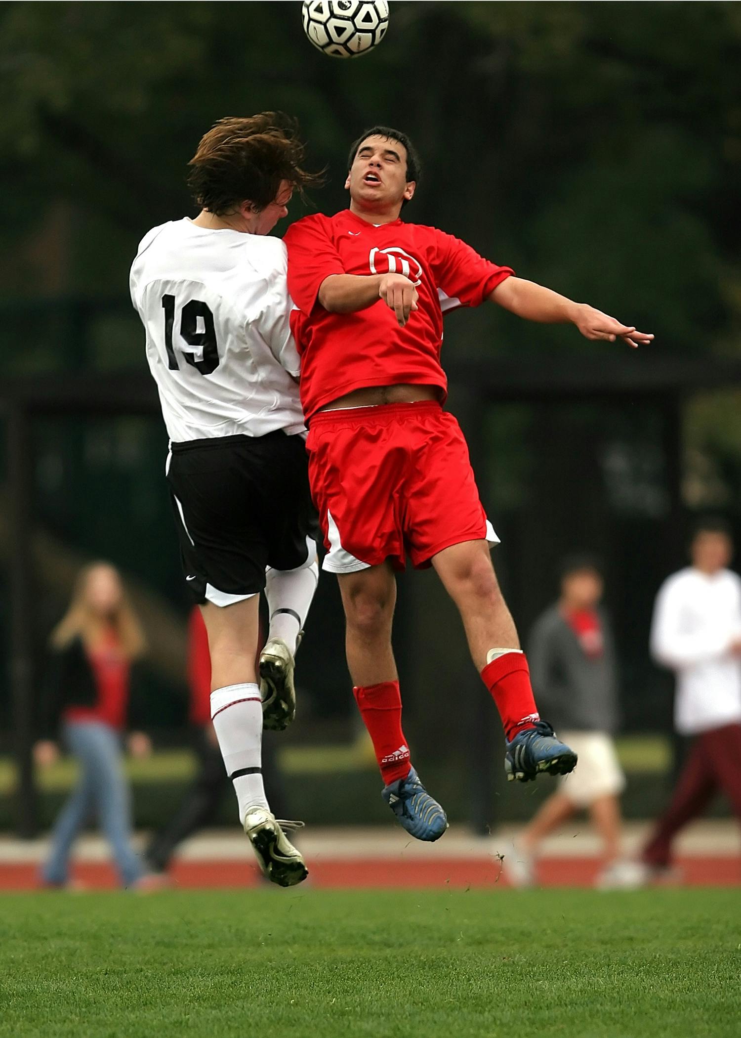 Two Soccer Players Competing for Header