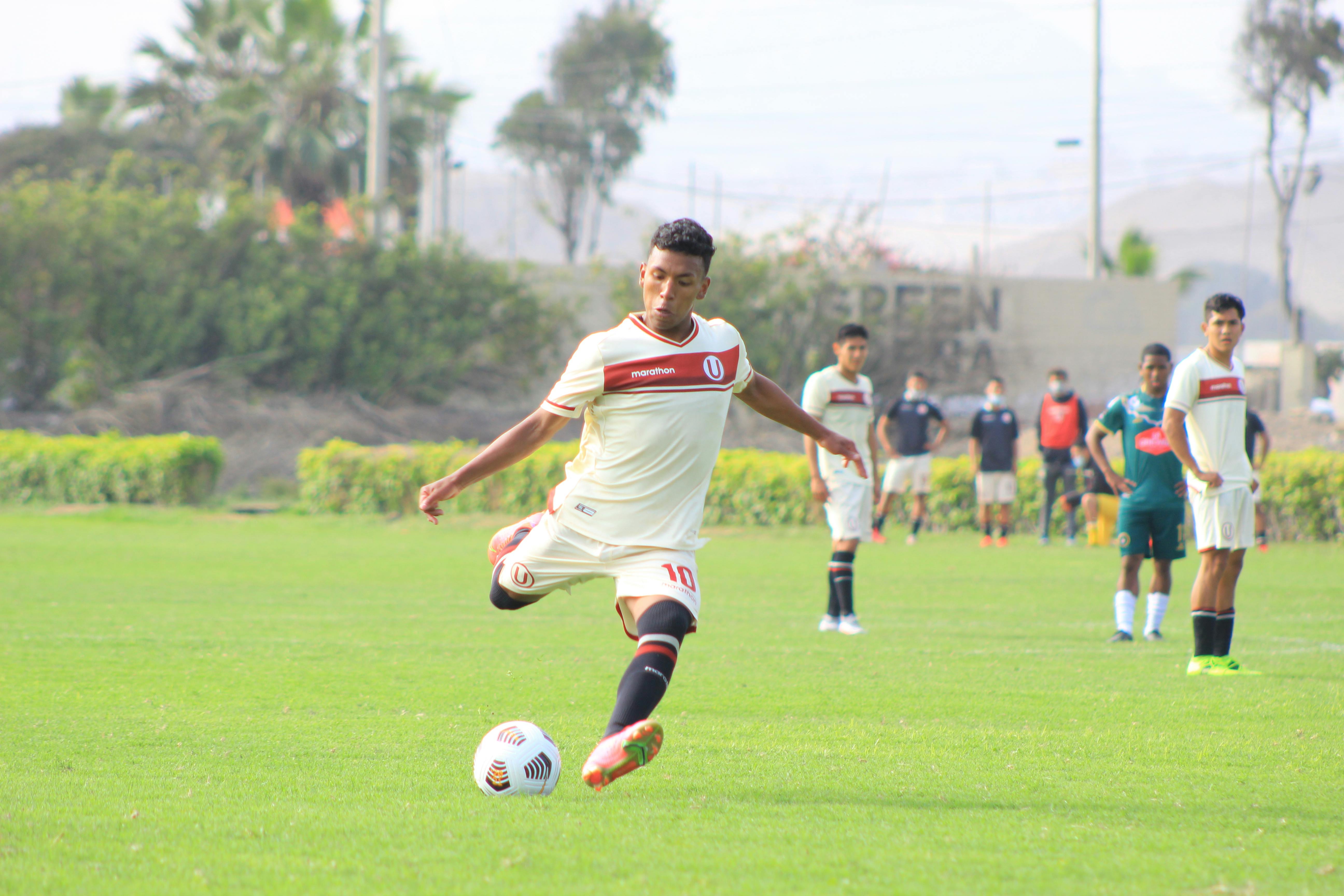 Soccer Player Kicking Ball On Field