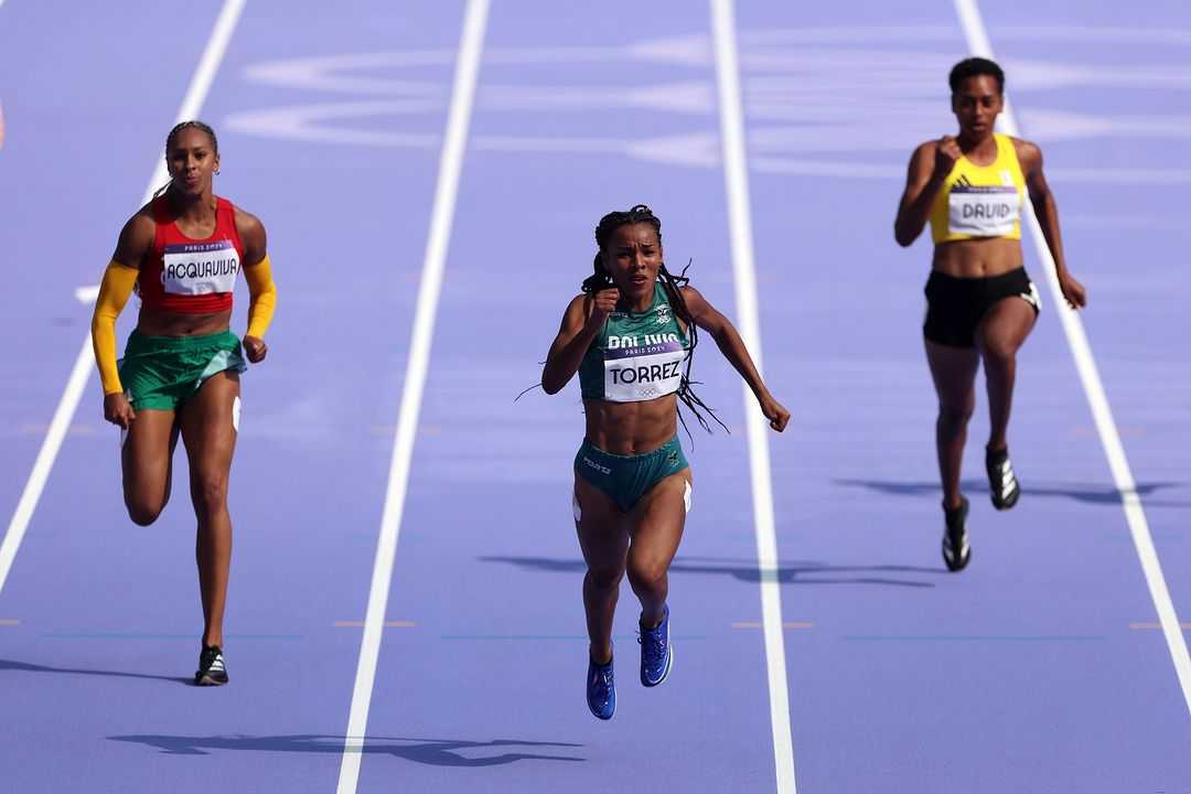 Three Female Sprinters Competing in Track Race