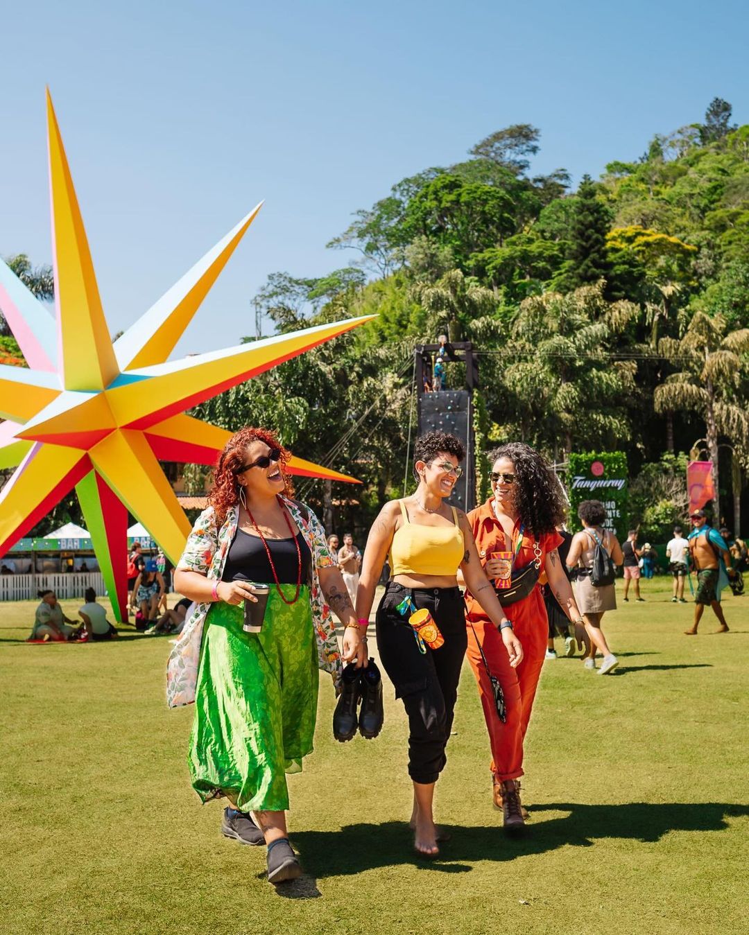 Three Women Walking At Outdoor Festival