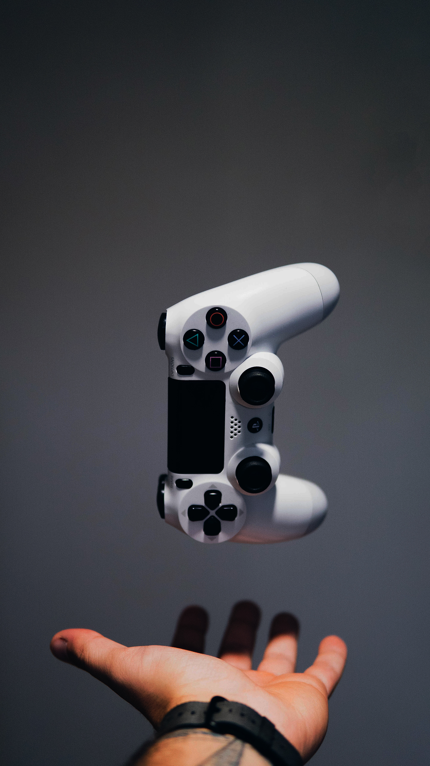 White PS Controller Floating Above Open Hand