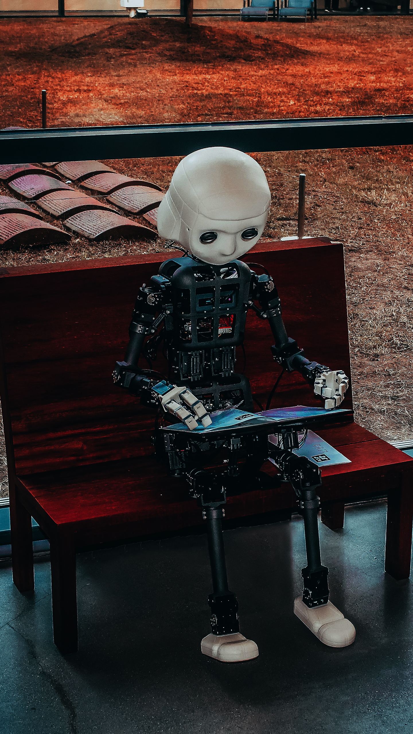 Humanoid Robot Reading on Bench