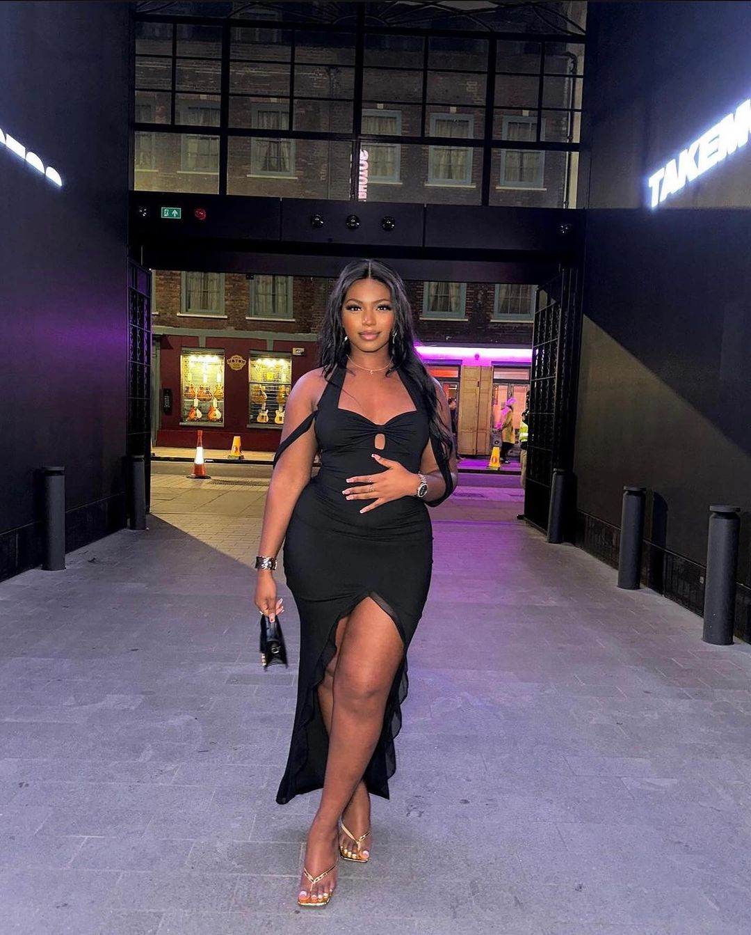 Woman Posing in Black Dress at Night
