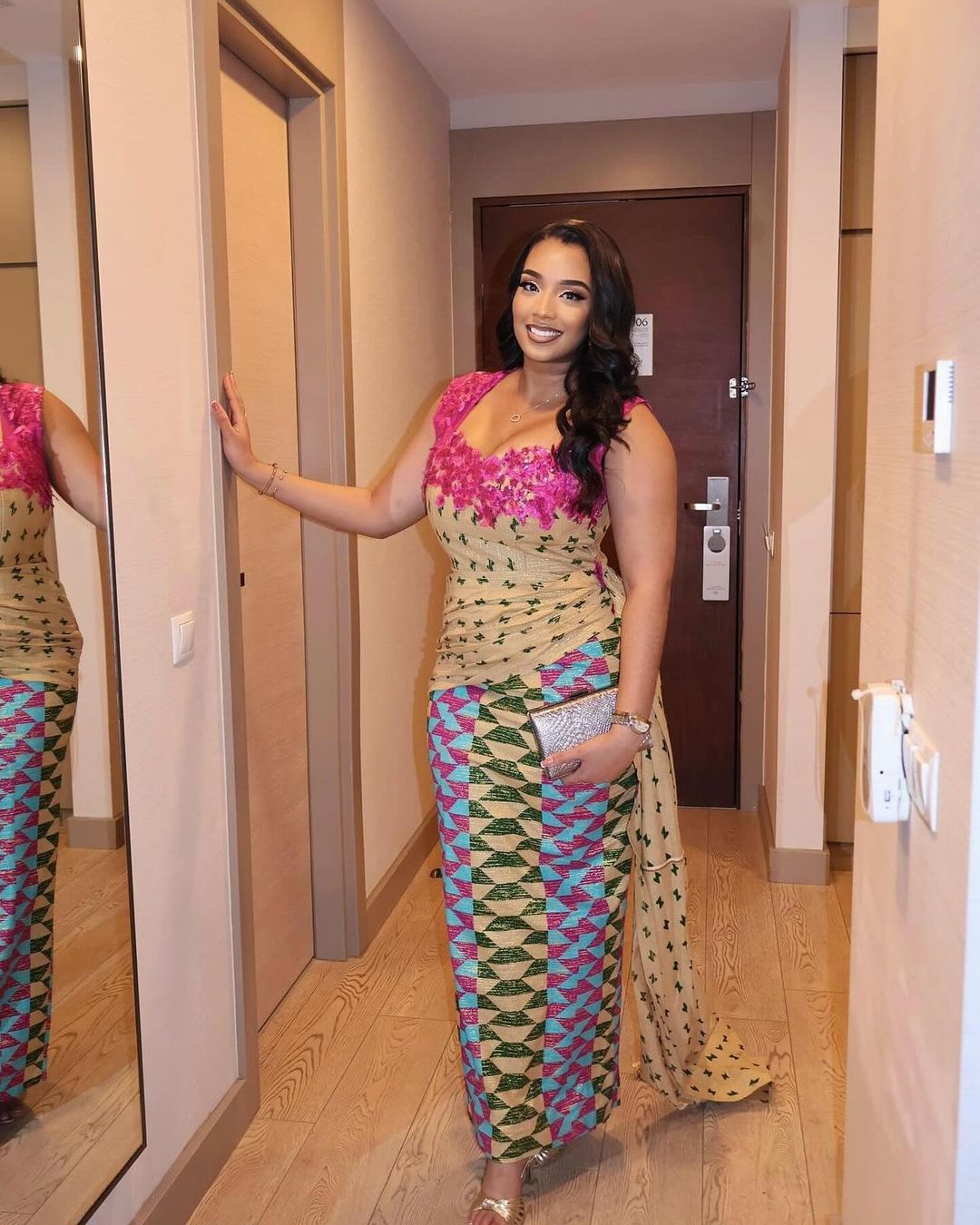 Woman in Printed Gown in Hotel Hallway
