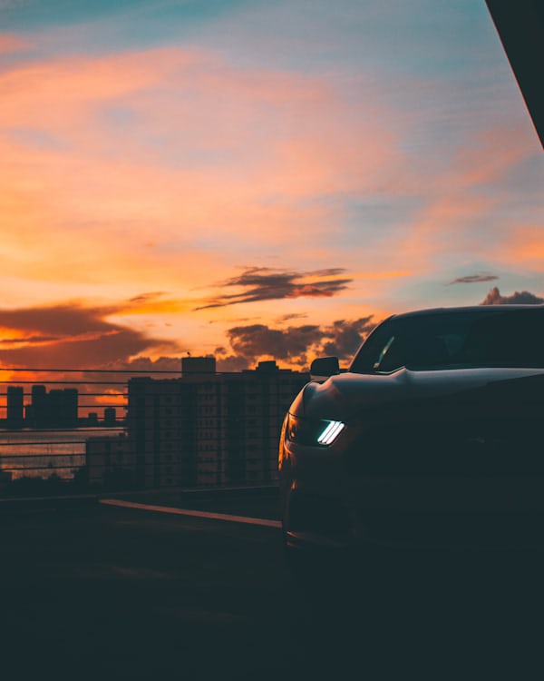 Sports Car Against Sunset City Skyline