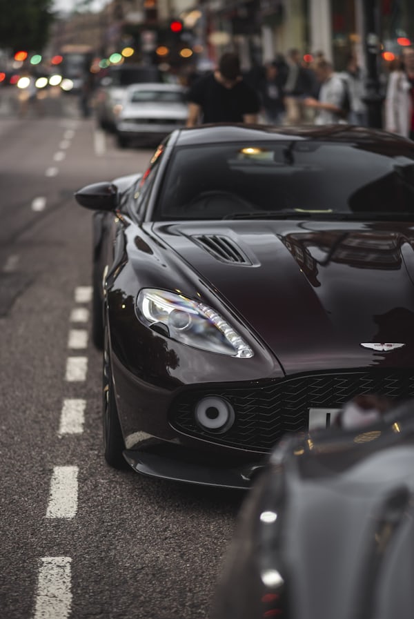 Dark Luxury Sports Car on City Street — Cars