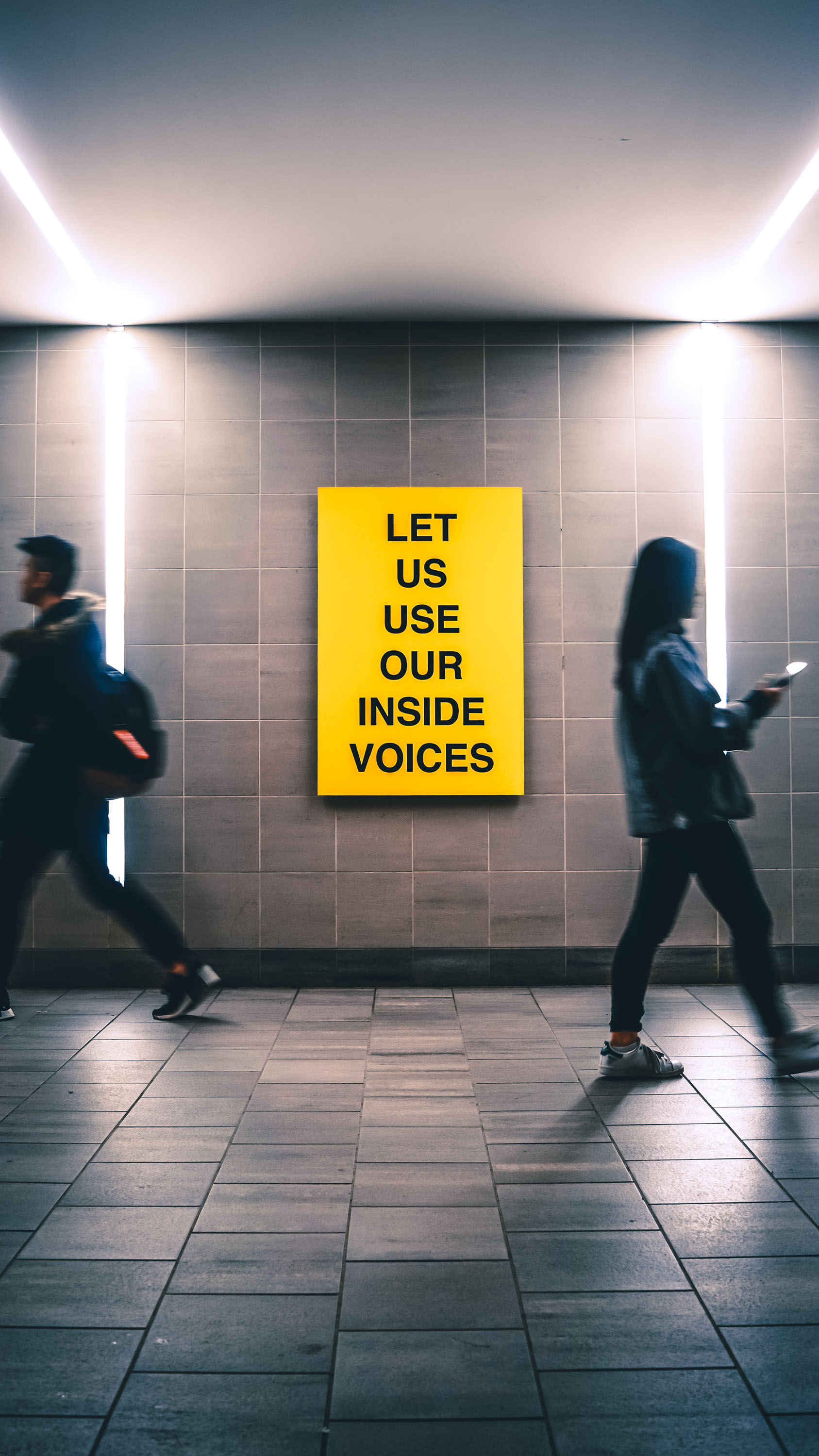 Inside Voices Sign in Indoor Walkway