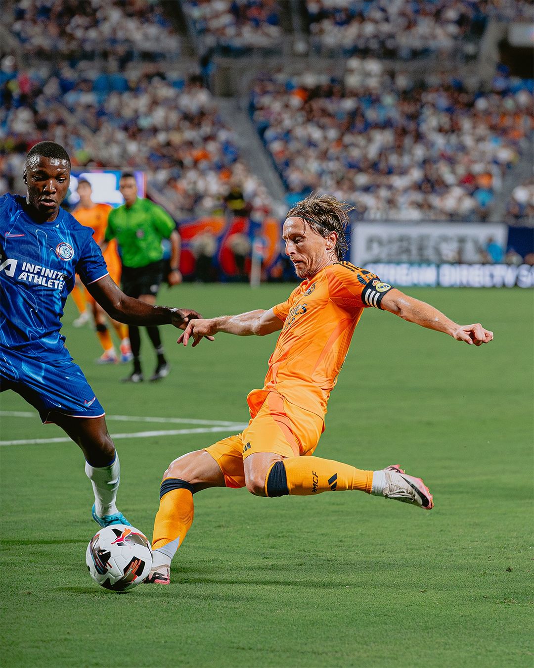 Modric Competes for Ball in Soccer Match