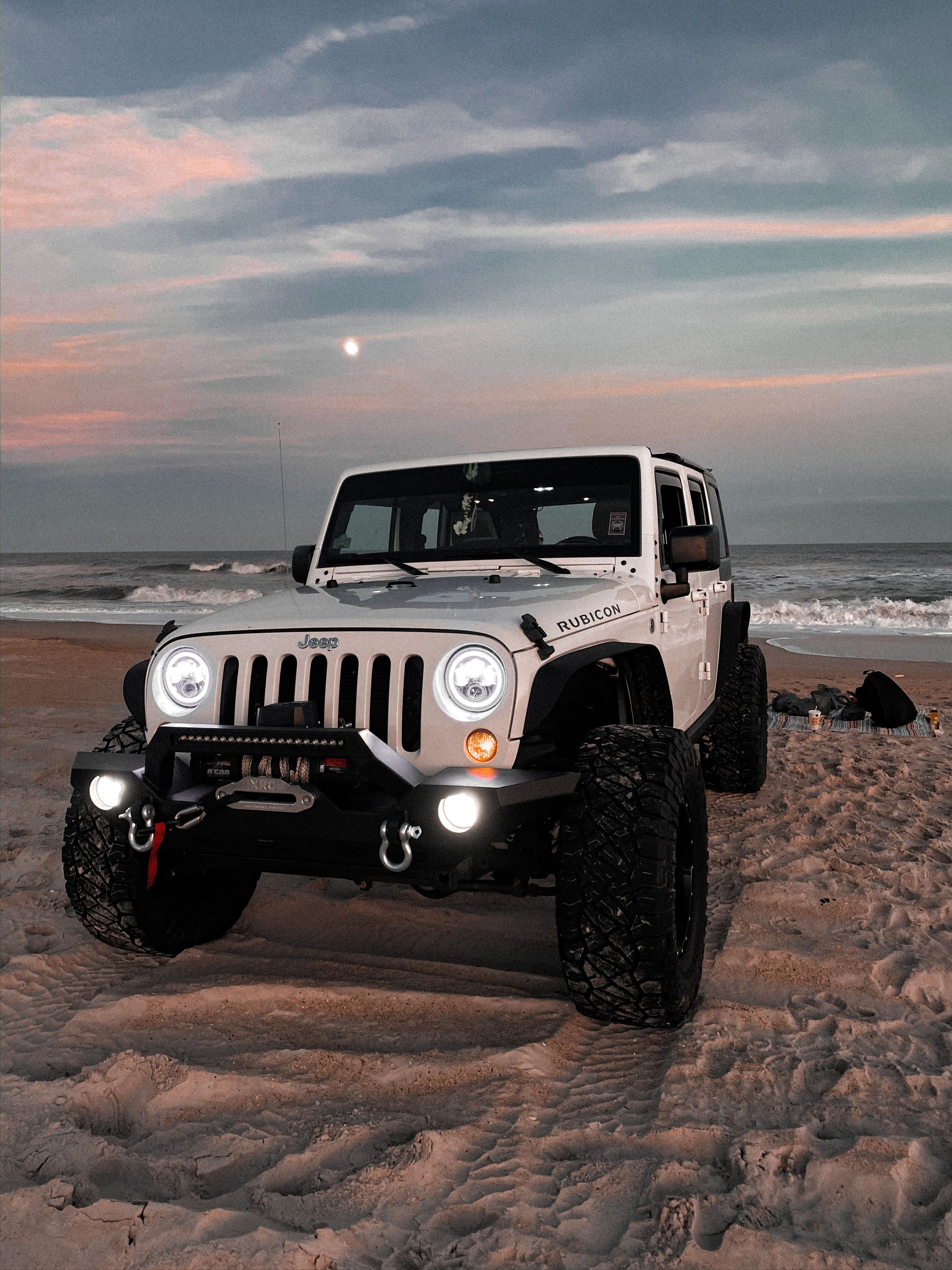 White Jeep Rubicon on Beach at Dusk