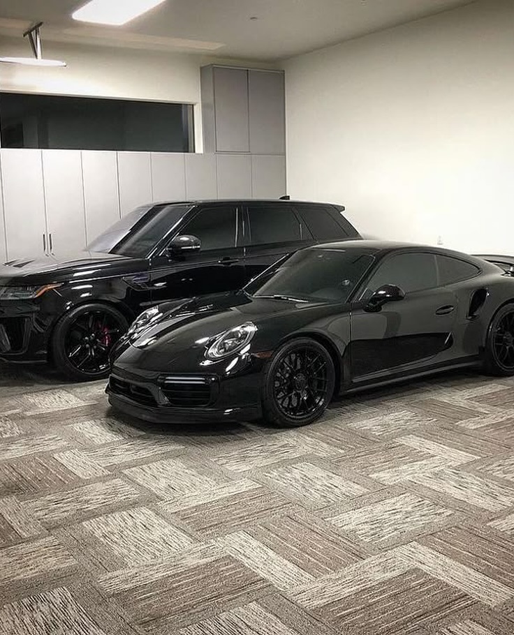 Two Black Luxury Cars in Indoor Garage
