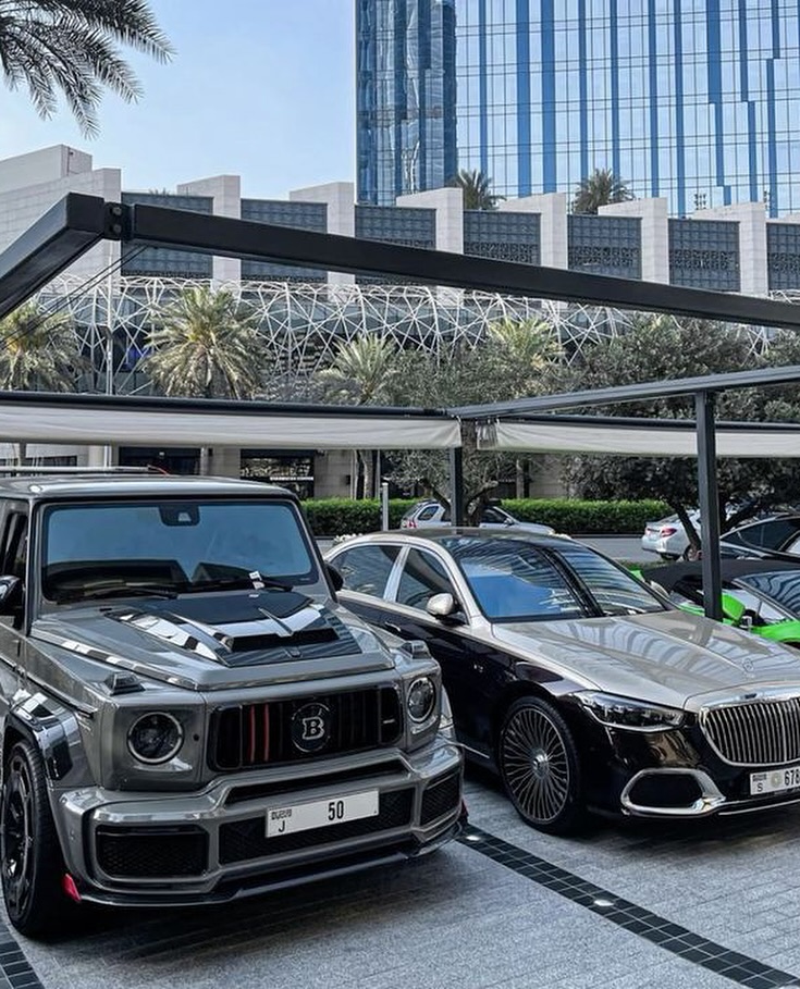 Two Luxury Cars Parked in Urban Parking