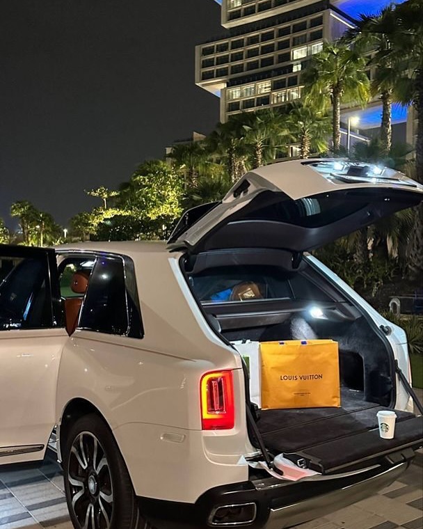 White Luxury SUV with Open Trunk at Night