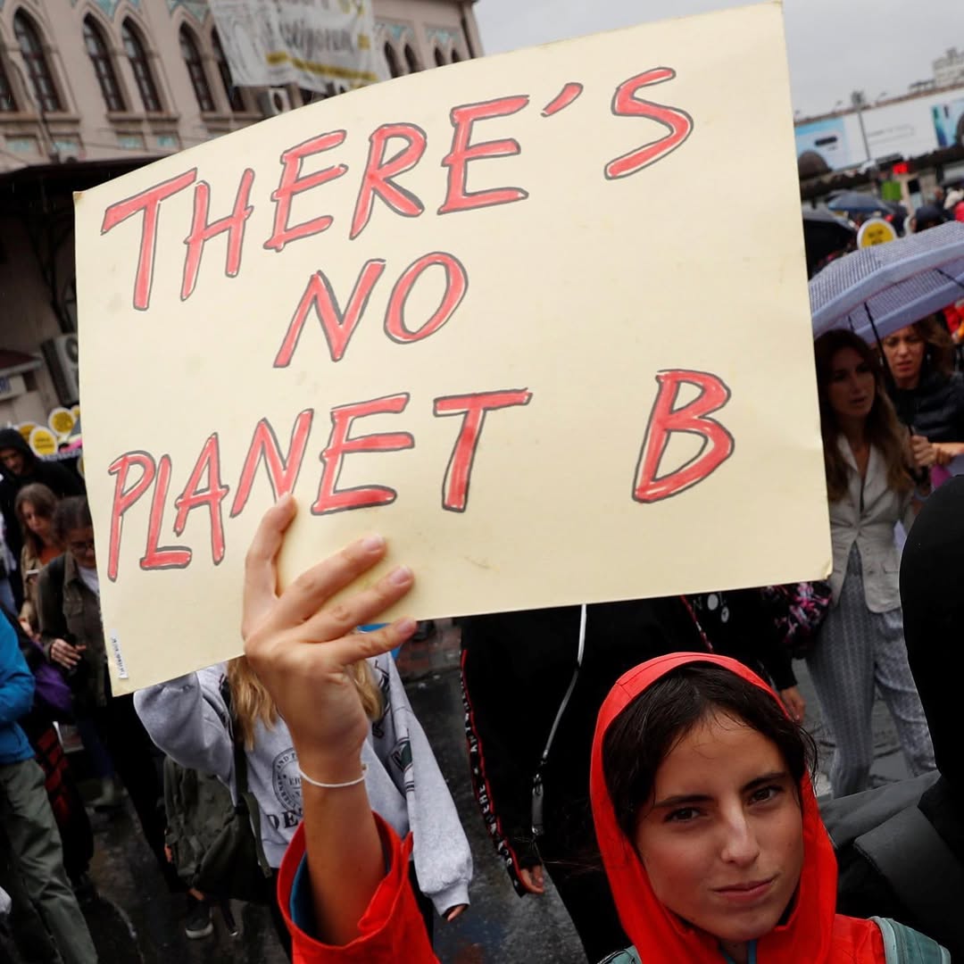Climate Activist Holding No Planet B Sign — Quotes