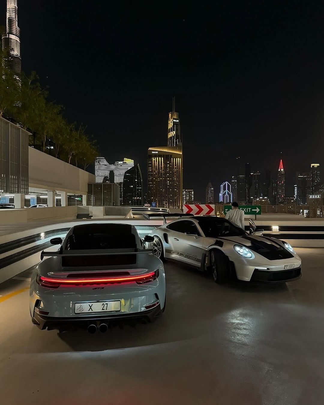 Two Porsches with Dubai Night Skyline