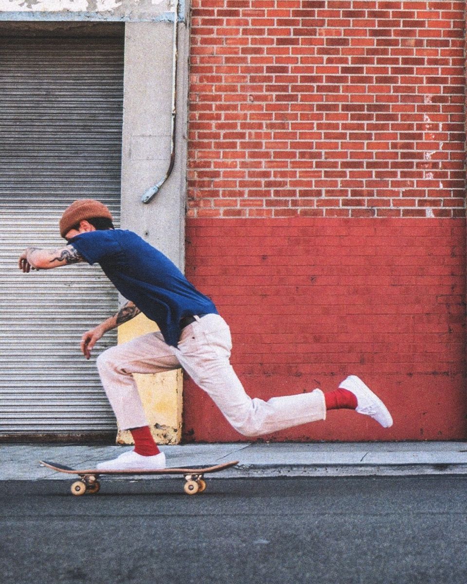 Skateboarder Pushing Off on City Street